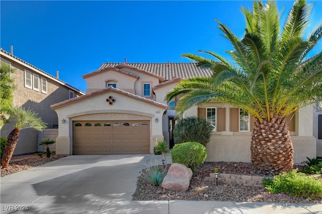 mediterranean / spanish-style house with a garage