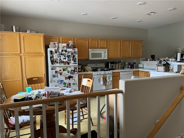 kitchen with white appliances and kitchen peninsula