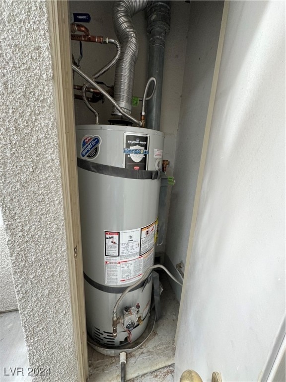 utility room featuring water heater