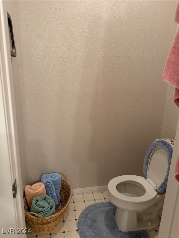 bathroom with tile patterned flooring and toilet