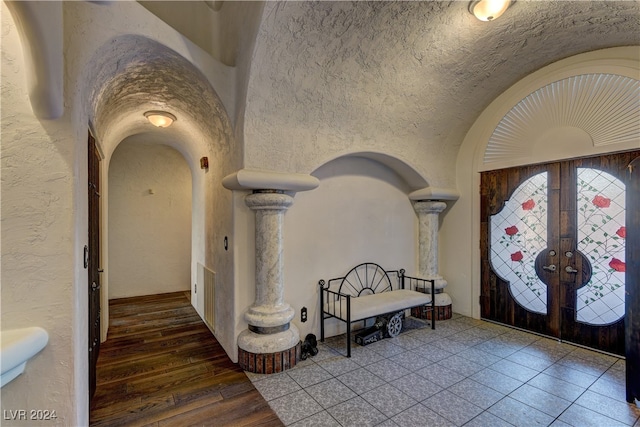 foyer entrance with wood-type flooring and french doors