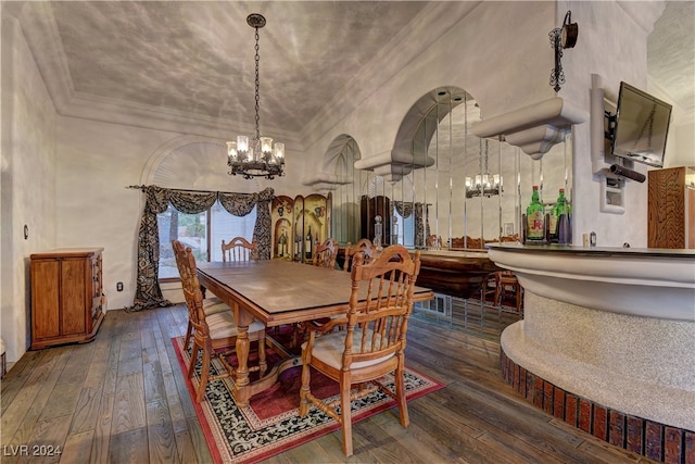 dining area with an inviting chandelier and dark hardwood / wood-style floors