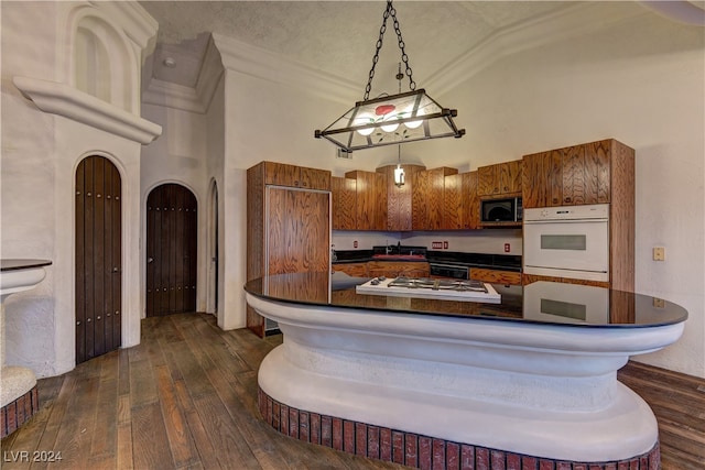 kitchen with hanging light fixtures, sink, black appliances, dark hardwood / wood-style floors, and a textured ceiling