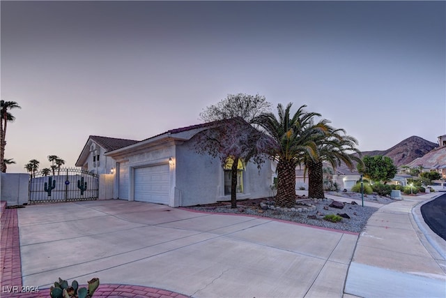 view of front of home with a mountain view and a garage