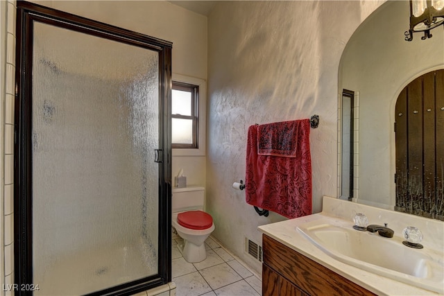 bathroom with an enclosed shower, tile patterned floors, toilet, and vanity