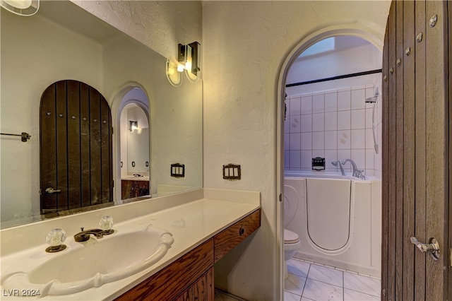 bathroom with tile patterned flooring, vanity, and toilet