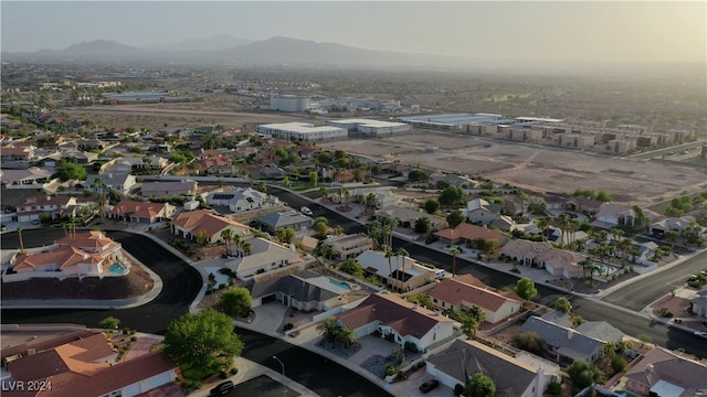 aerial view at dusk featuring a mountain view