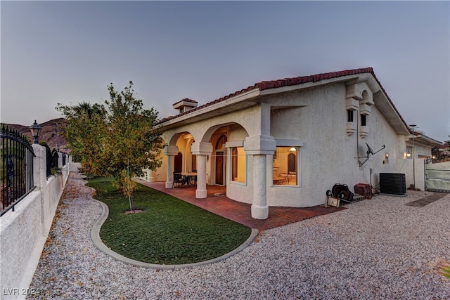 view of side of home featuring central air condition unit and a patio