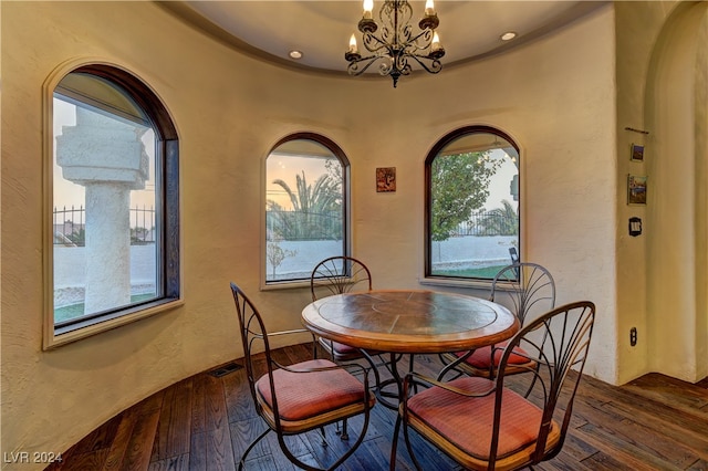 dining area featuring dark hardwood / wood-style floors and a notable chandelier