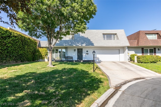 view of front of property featuring a garage and a front yard