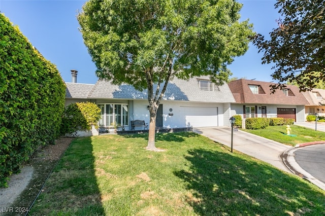 view of front of house featuring a garage and a front lawn