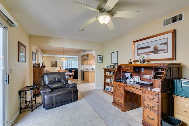 carpeted office space featuring ceiling fan