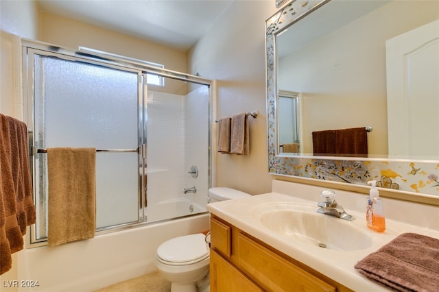 full bathroom featuring combined bath / shower with glass door, vanity, and toilet