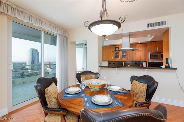 dining space with light hardwood / wood-style floors