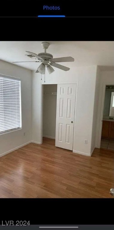 unfurnished bedroom featuring light wood-type flooring, ceiling fan, and a closet