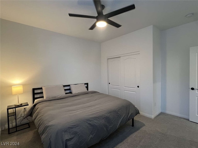 carpeted bedroom with ceiling fan and a closet