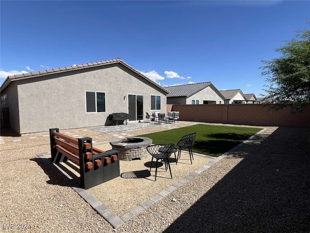 exterior space featuring a lawn, a patio, and an outdoor fire pit