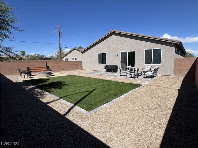 rear view of property with a lawn and a patio