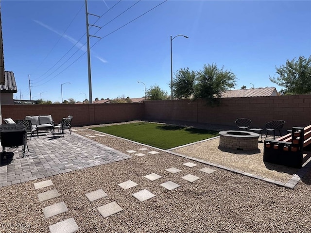 view of yard featuring a patio area and an outdoor fire pit