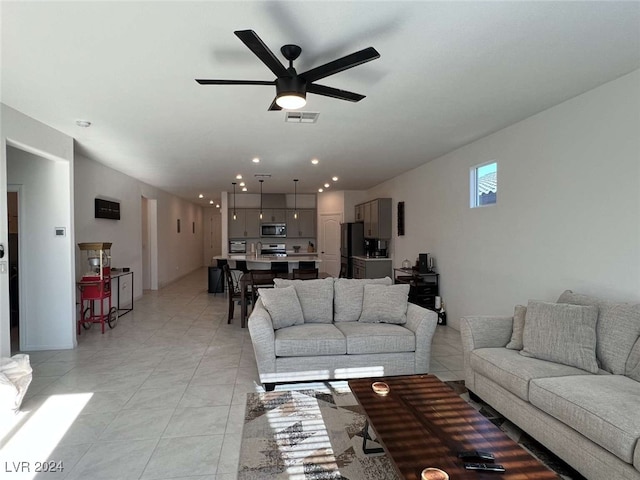 tiled living room with ceiling fan