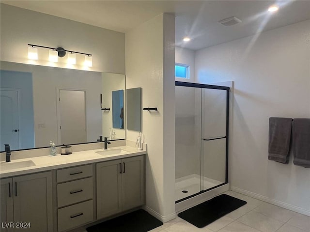 bathroom with walk in shower, tile patterned flooring, and vanity