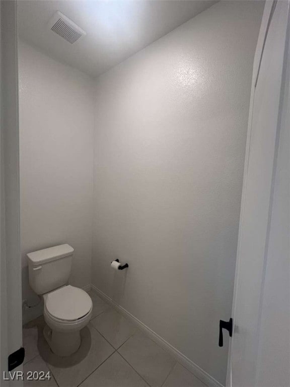 bathroom with toilet and tile patterned floors