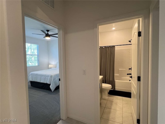 bathroom featuring ceiling fan, tile patterned flooring, toilet, and shower / bath combo