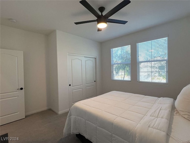 bedroom featuring carpet, ceiling fan, and a closet