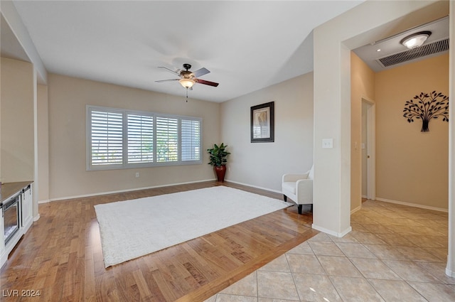 sitting room featuring ceiling fan and light hardwood / wood-style floors