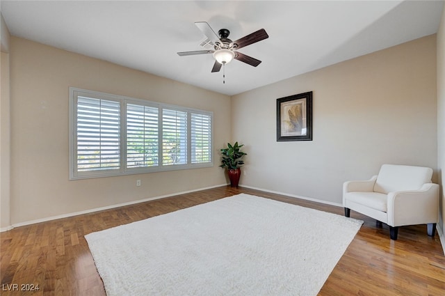 sitting room featuring ceiling fan and hardwood / wood-style flooring