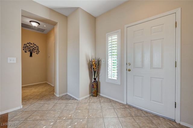 entryway with light tile patterned floors