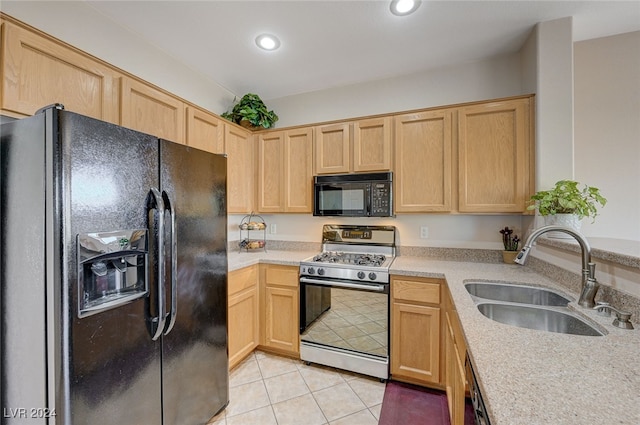 kitchen with light brown cabinets, sink, and black appliances