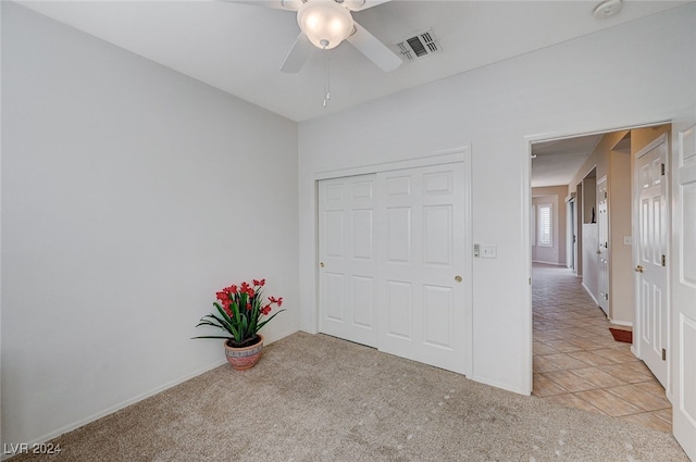 carpeted empty room with ceiling fan