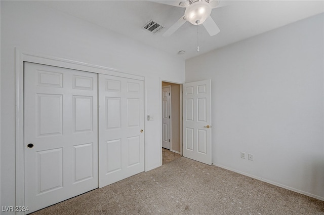 unfurnished bedroom featuring ceiling fan, light colored carpet, and a closet