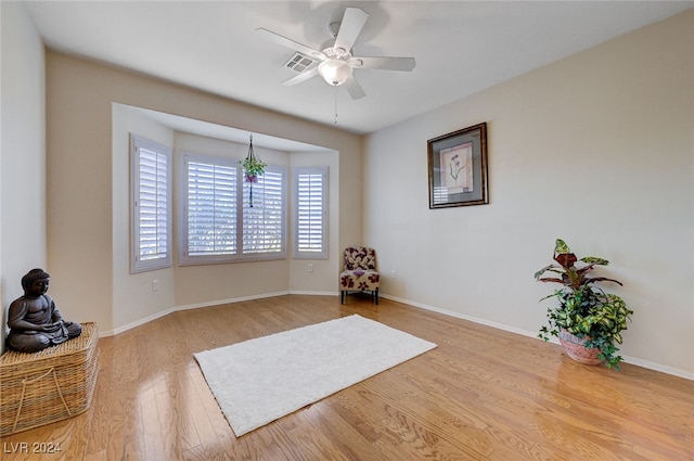 sitting room featuring ceiling fan and light hardwood / wood-style floors