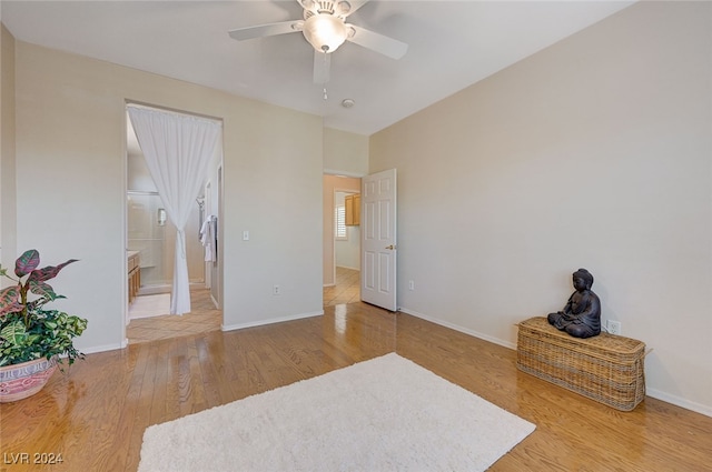 bedroom featuring wood-type flooring, connected bathroom, and ceiling fan