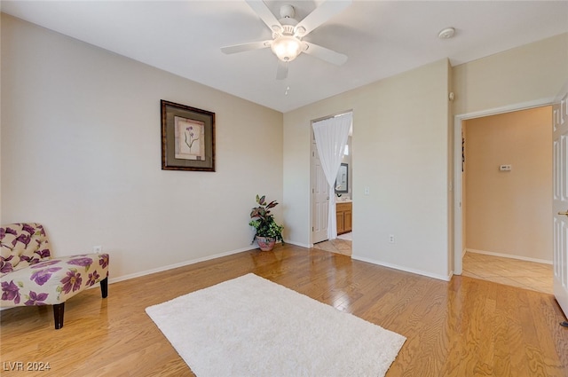 sitting room featuring ceiling fan and light wood-type flooring