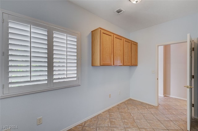 spare room with light tile patterned floors