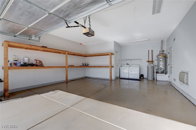 garage featuring separate washer and dryer, a garage door opener, and water heater