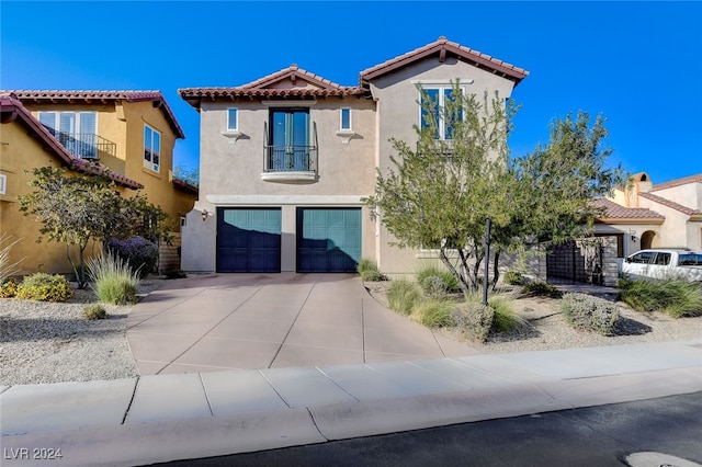 mediterranean / spanish-style house with a garage