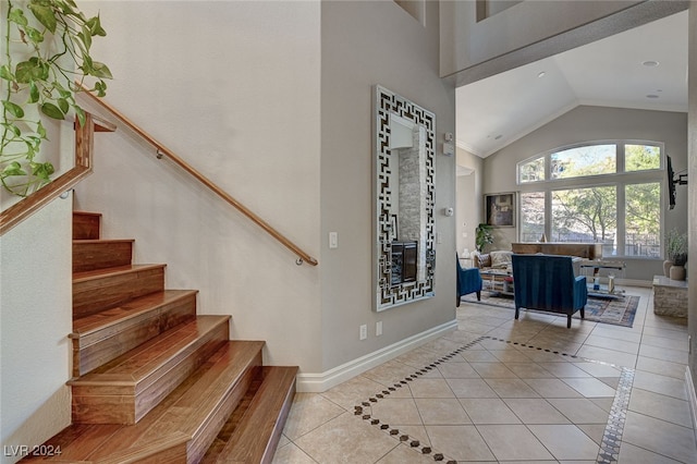 stairs featuring vaulted ceiling and tile patterned floors