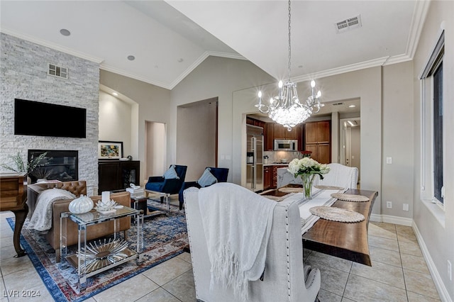 tiled dining room with high vaulted ceiling, a fireplace, an inviting chandelier, and crown molding