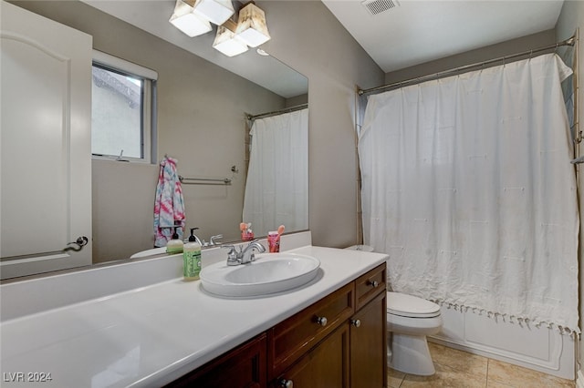 full bathroom featuring shower / bath combo, tile patterned flooring, vanity, and toilet