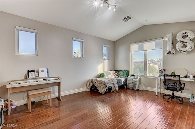 bedroom with dark hardwood / wood-style flooring and vaulted ceiling