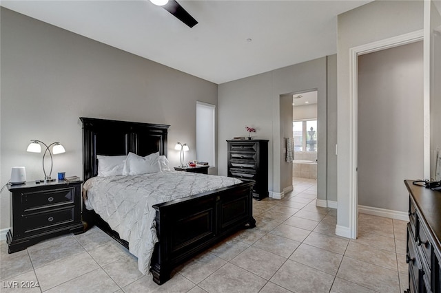 tiled bedroom with ceiling fan and connected bathroom