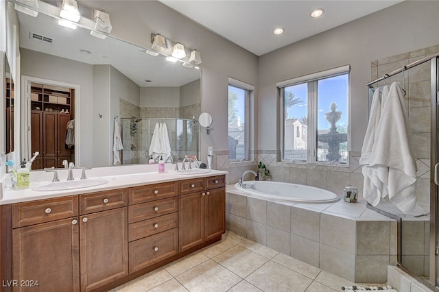 bathroom with shower with separate bathtub, tile patterned floors, and vanity