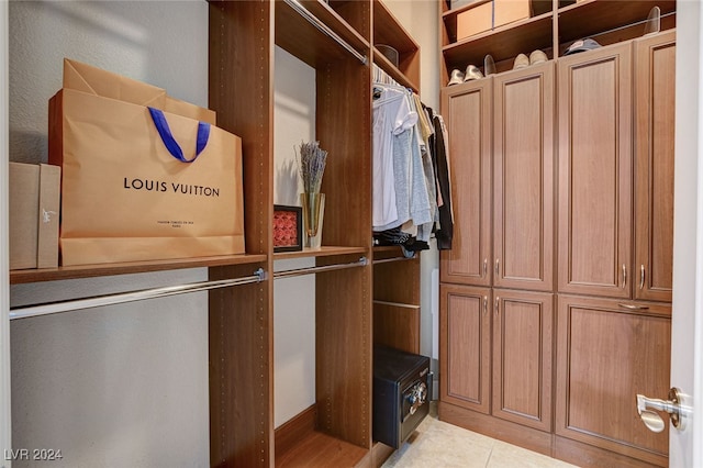 spacious closet with light tile patterned floors