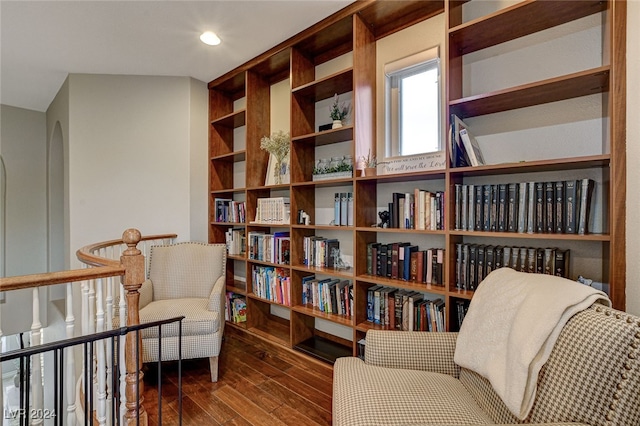 living area with vaulted ceiling and dark hardwood / wood-style flooring