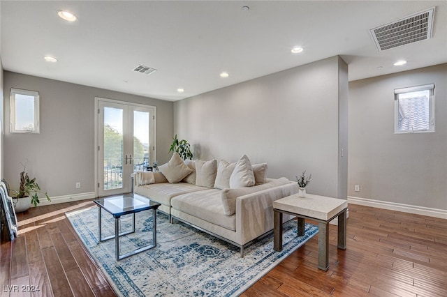 living room with wood-type flooring and french doors