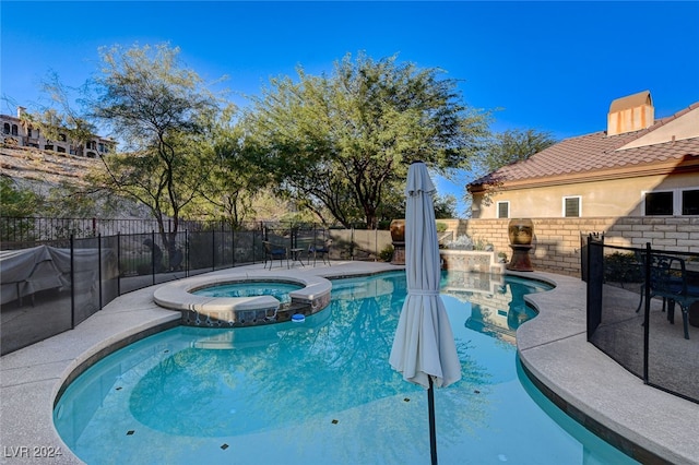 view of pool with an in ground hot tub